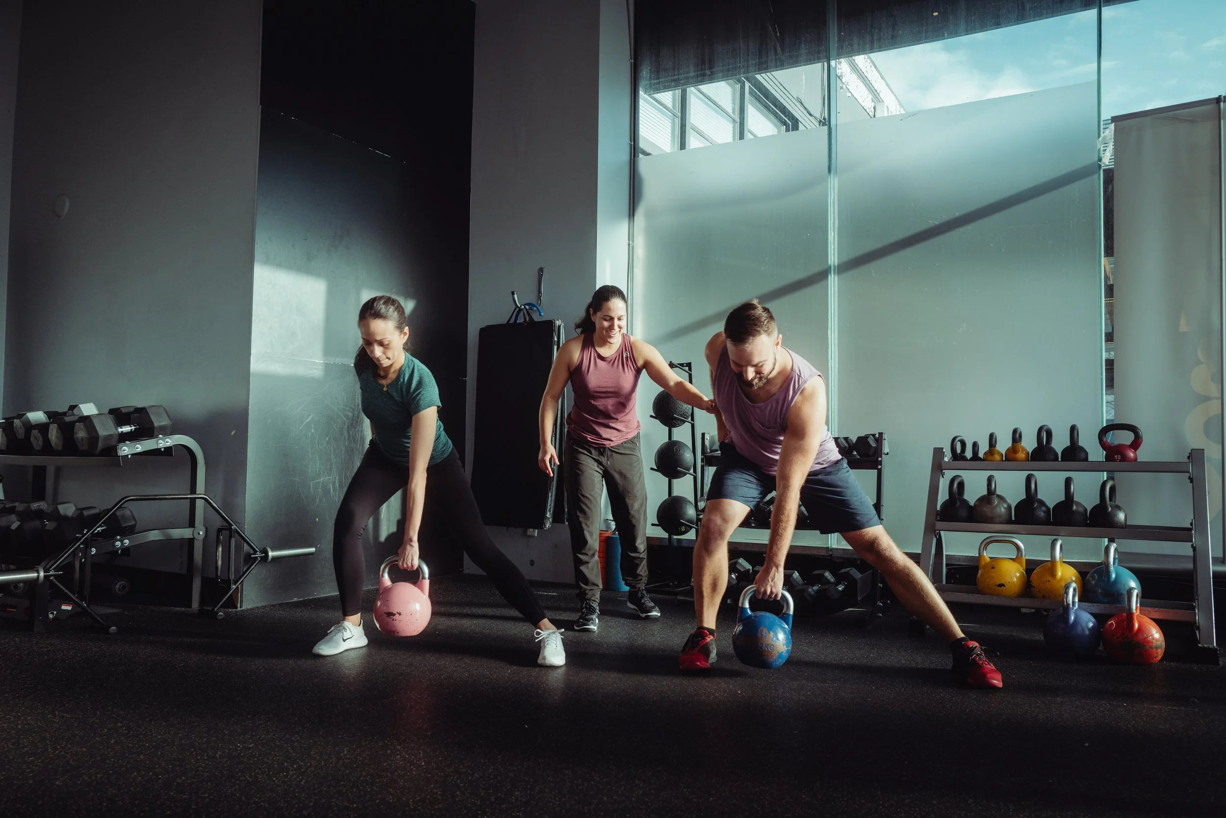Kettlebell lateral lunge during group training in Vancouver