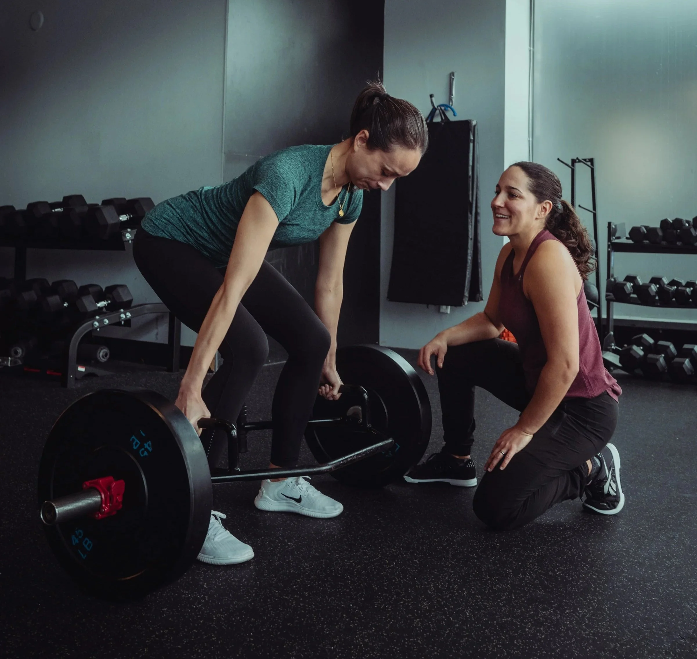 Runner performing a trap bar deadlift with a coach at Avos Strength in Vancouver