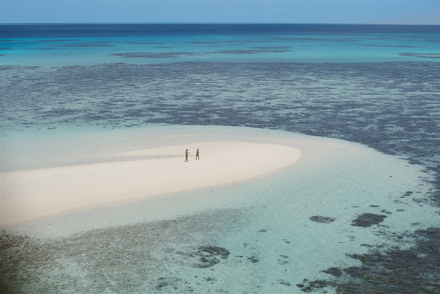 couple-walking-on-white-sand-cay.jpg