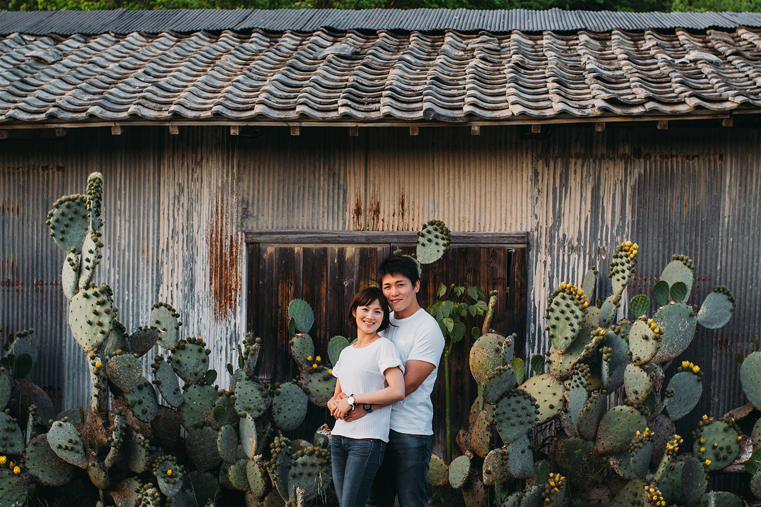 couple-standing-in-front-of-cactus-tree.jpg
