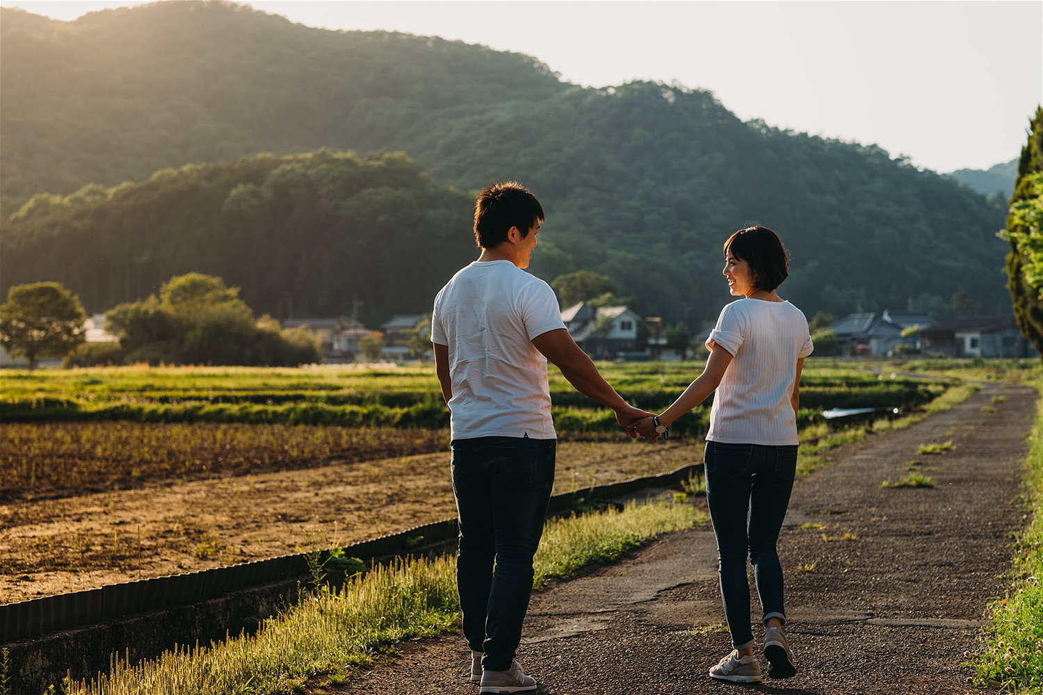 couple-walking-in-natural-light-in-rice-field.jpg