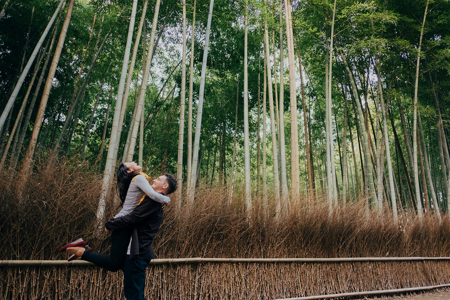 husband-holding-wife-high-in-bamboo-forest-kyoto.jpg