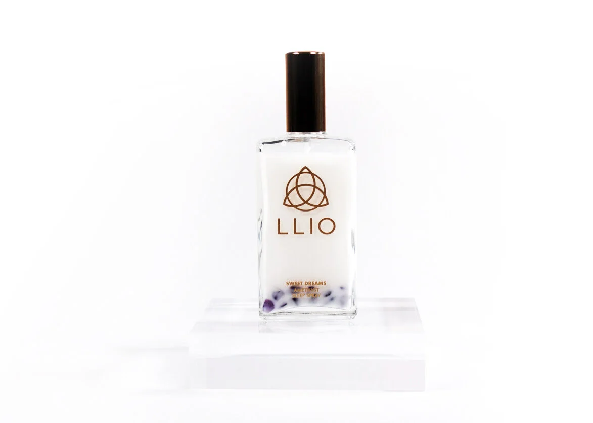 Sweet Dreams Lavender Sleep Spray bottle on a raised platform