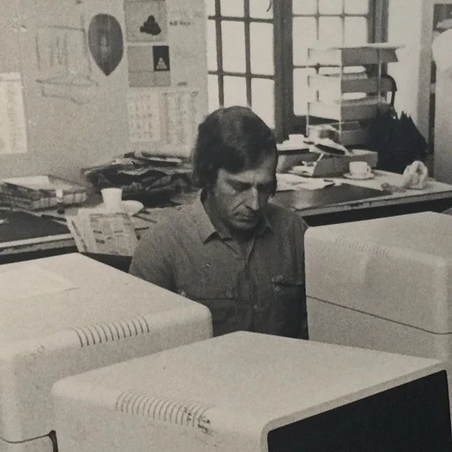 My Dad is surrounded by other Cape Town Argus journalists in the original  of this newsroom photo, taken when Atex computers had arrived, in a time before PCs. 
Owen has written on the reverse, &lsquo;Crowd of &lsquo;happy&rsquo; people on Atex. See 