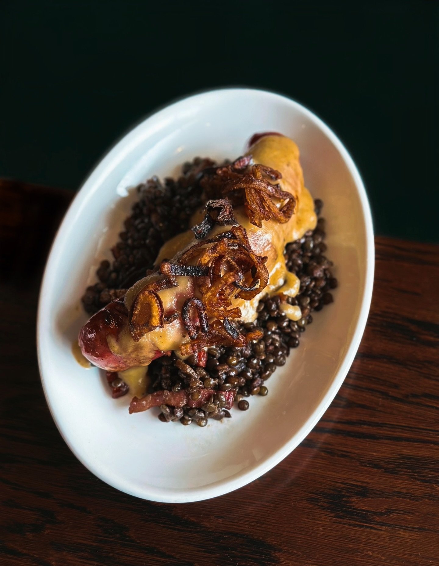 Answering cold &amp; rain with comfort &amp; indulgence.
⠀⠀⠀⠀⠀⠀⠀⠀⠀
Now on the menu &mdash; Traditional Saucisse de Toulouse from southwest France, charcoal grilled, served with buttery lentils, finished with apple &amp; sage pur&eacute;e, topped with