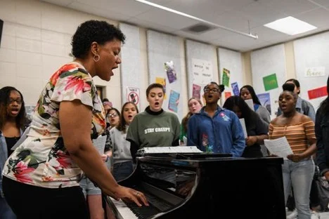 Music teacher Toni Daniels leads the student choir in song at Parkside High School in Salisbury on Tuesday, April 9, 2019.