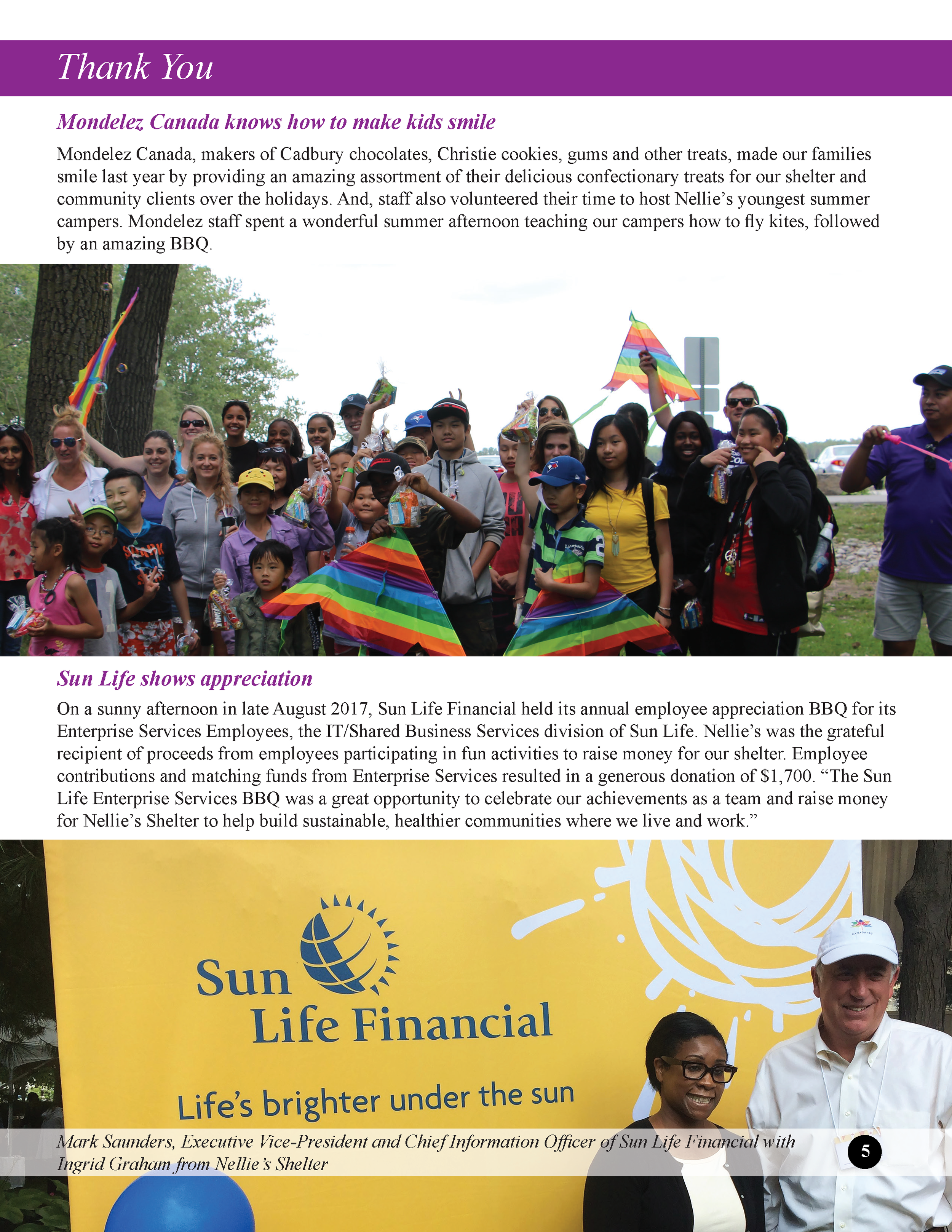 Group of children and adults outdoors celebrating at a Sun Life Financial employee appreciation BBQ, with colorful flags and a large Sun Life Financial banner in the background.