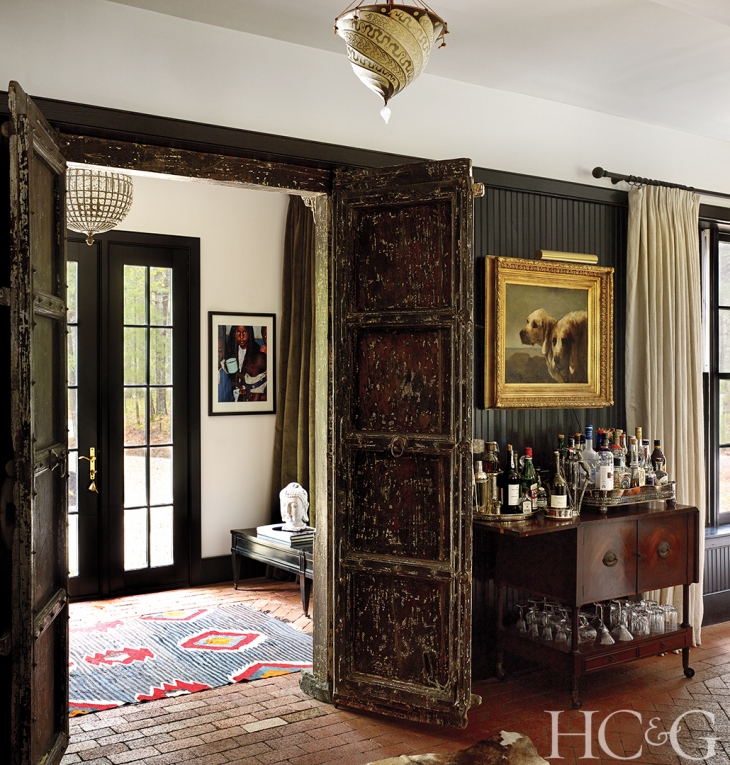  Decorative Indian mahogany doors from the late 1800s beckon in the entryway; the bar dates from the 1930s. 