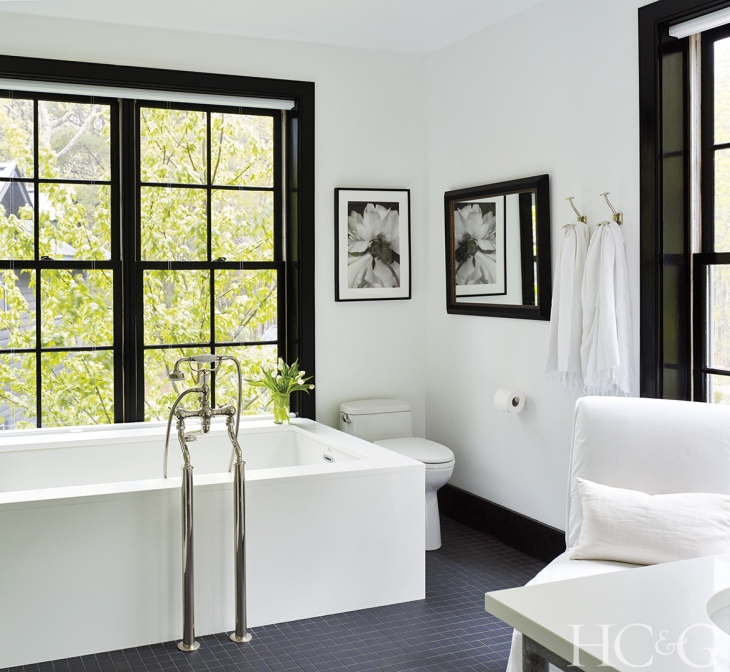  The bathtub is sheathed in  Caesarstone . 