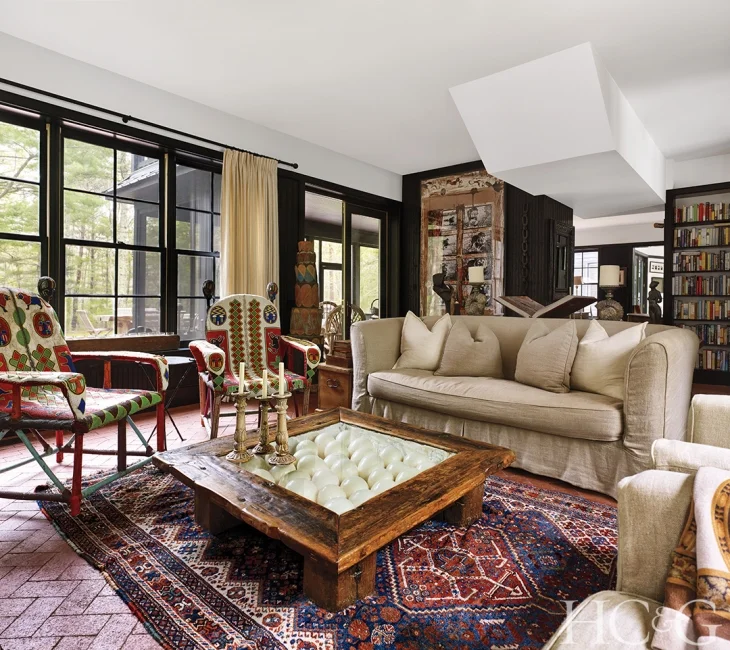 The living room features beaded armchairs from Nigeria and a Kenyan coffee table constructed from beached dhow wood. Ostrich eggs are housed beneath its glass top.