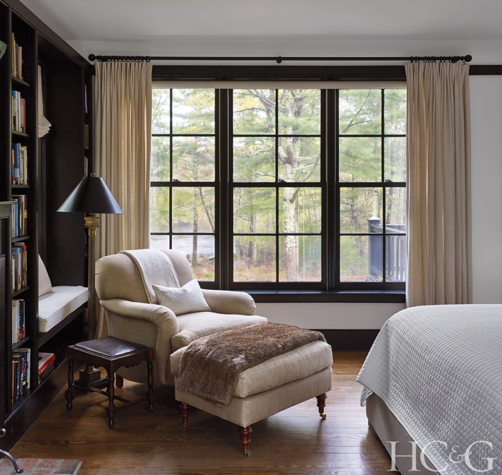 The master suite is outfitted with numerous seating areas for enjoying vistas of Larkin Pond or reading by the fire, such as a wood-and-cane daybed from India.