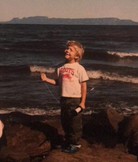 Jesse O’Neil, age 5, kite-flying on the shores of Lake Superior, with his beloved ‘Sleeping Giant’ in the background. “The sky’s the limit!”