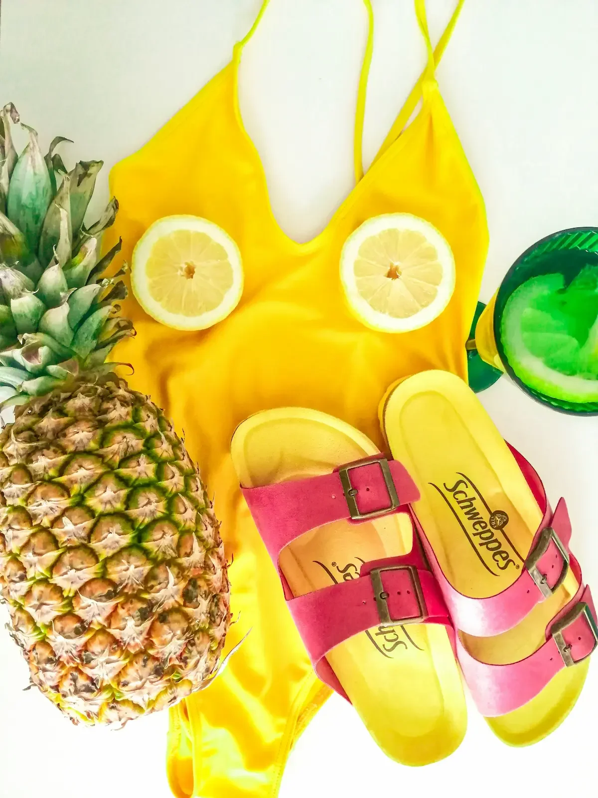 Yellow swimsuit with pineapple and pink slider sandals