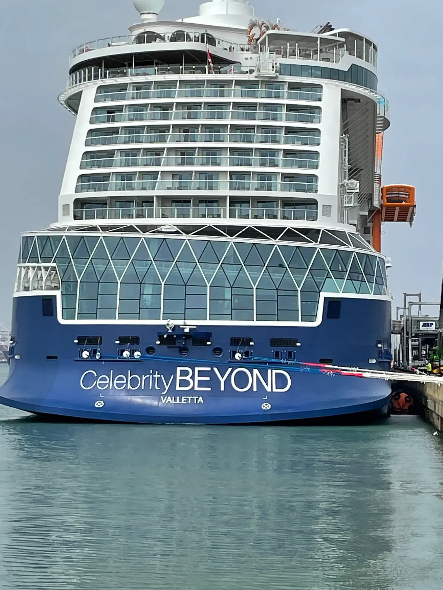 Aft view of Celebrity Beyond showing sunset bar, sunset view cabins and the tangerine Magic Carpet bar/restaurant on the starboard side