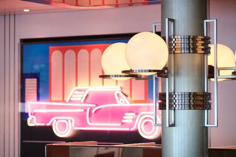 Neon Pink illuminated car wall decoration in 6th Street Diner on P&O Cruises Arvia