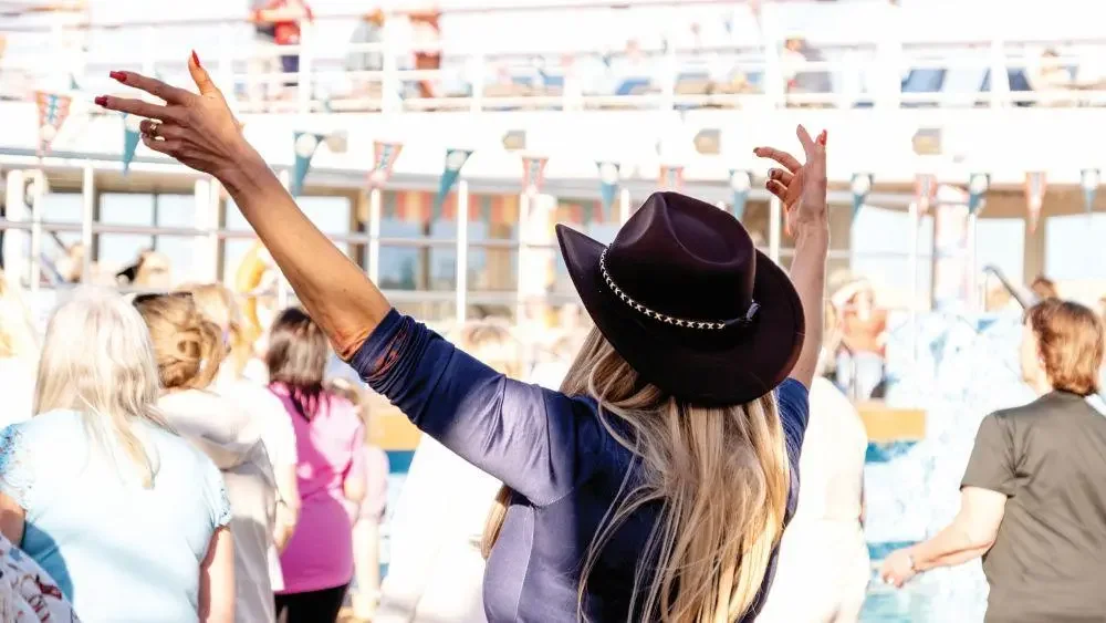Line dancers on Marella Cruises Country Rhythms Themed cruise in cowboy hat.