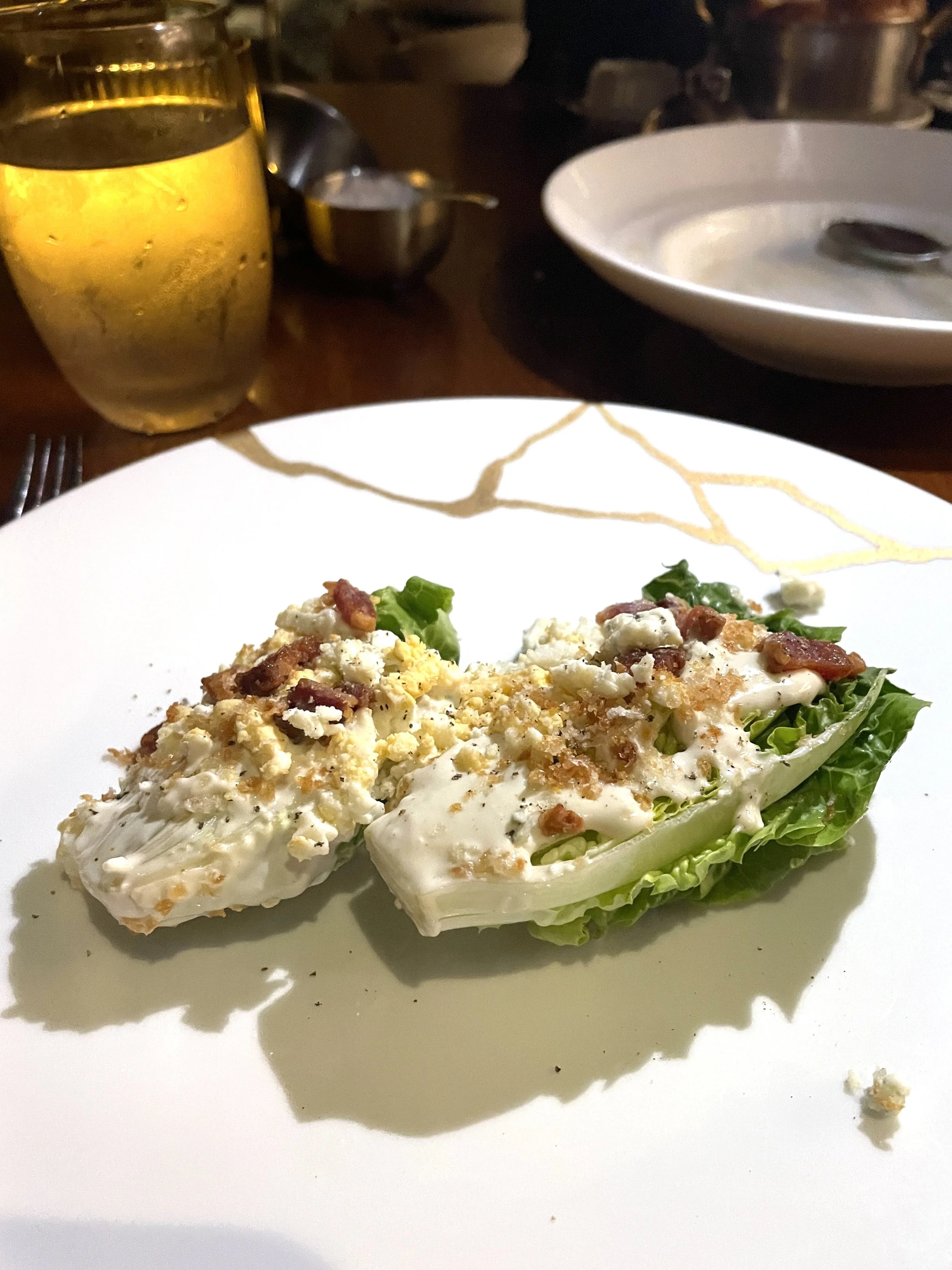 Crisp and delicious iceberg wedge salad with blue cheese dressing. Served as an appetiser in the Wake on Virgin Viyages Resilient Lady