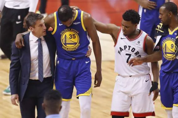 Warriors Kevin Durant and Raptors Kyle Lowry after Durant went down with a leg injury in game 5