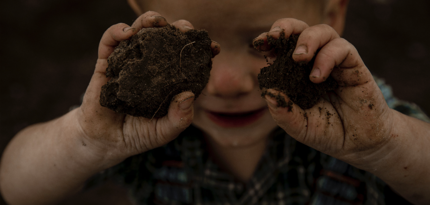 Jude playing with mud.