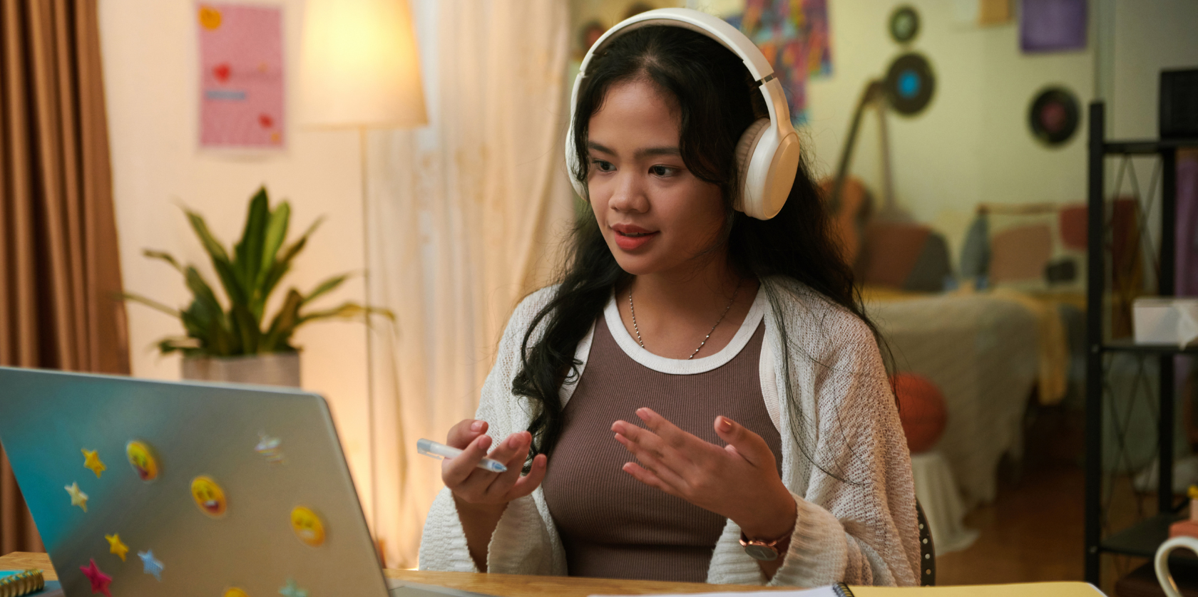Adult learner wearing headphones during an online Spanish class, practicing conversational Spanish from home