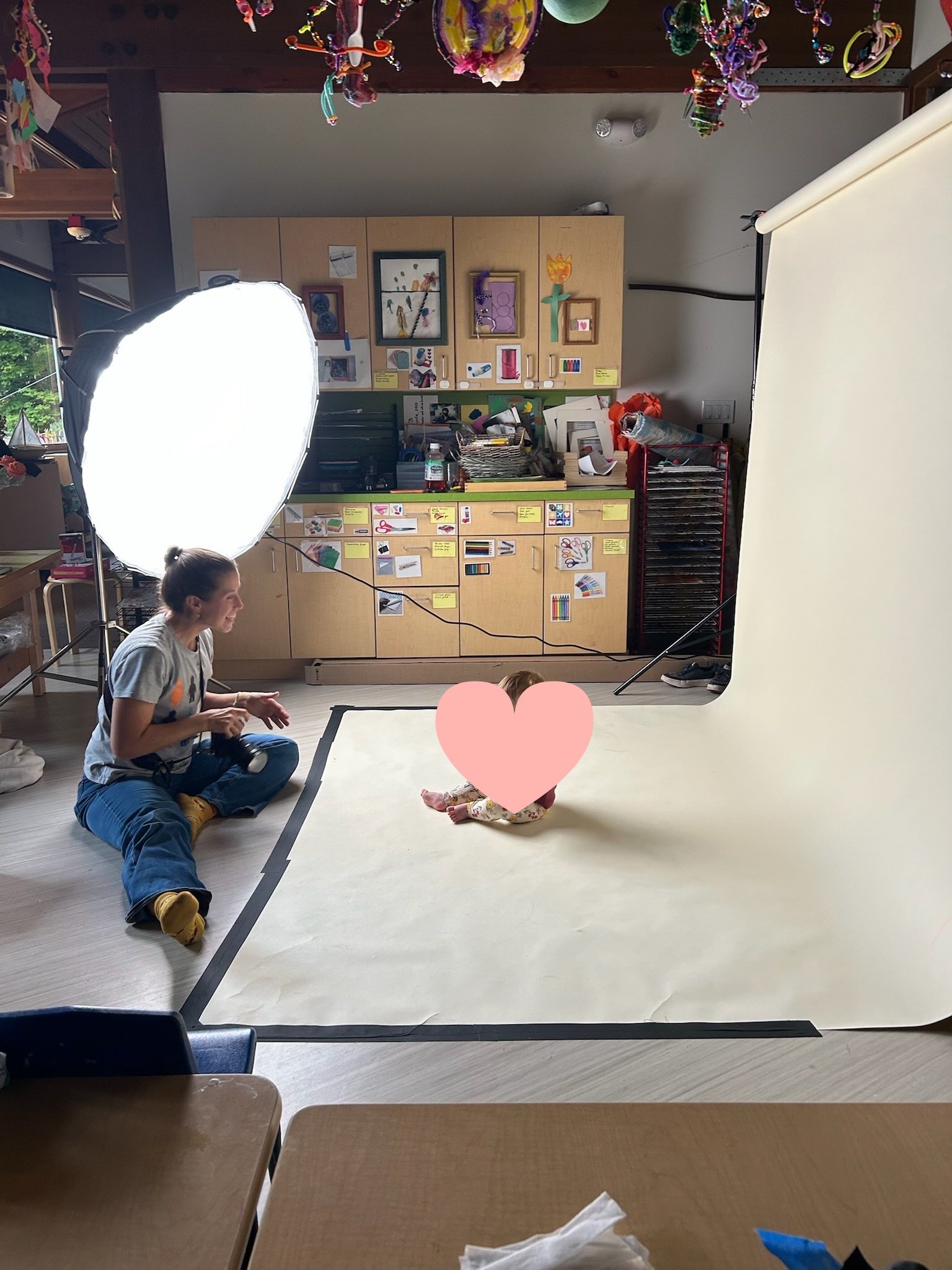 Anela photographs a baby at a school in Seattle, WA