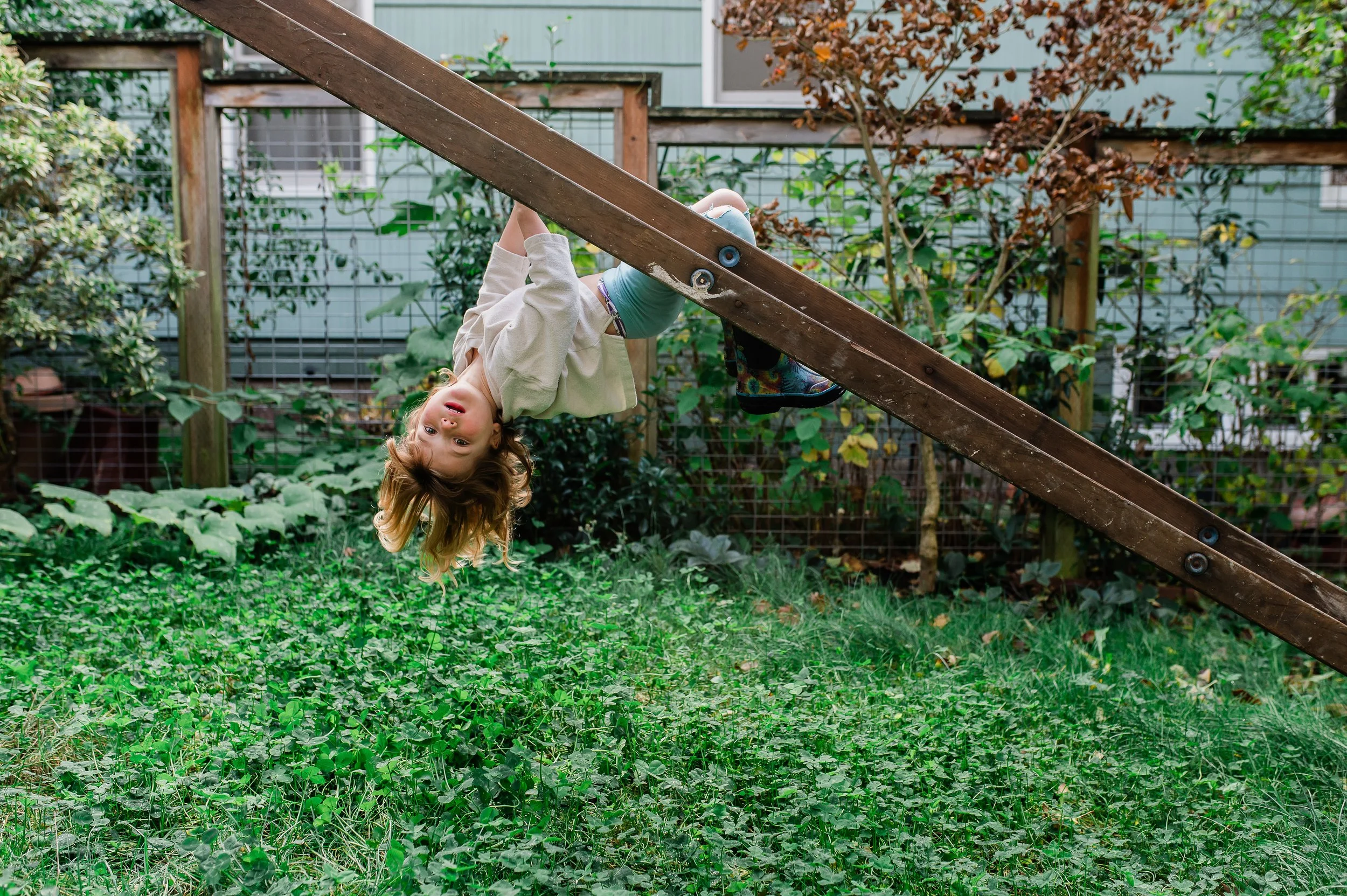 Seattle Family PHotograher girl hanging on tree in her home.