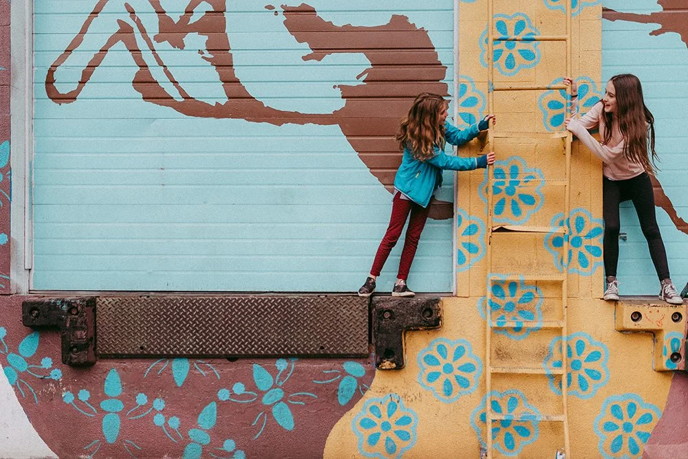 seattle teens in front of a mural in capitol hill at a photoshoot