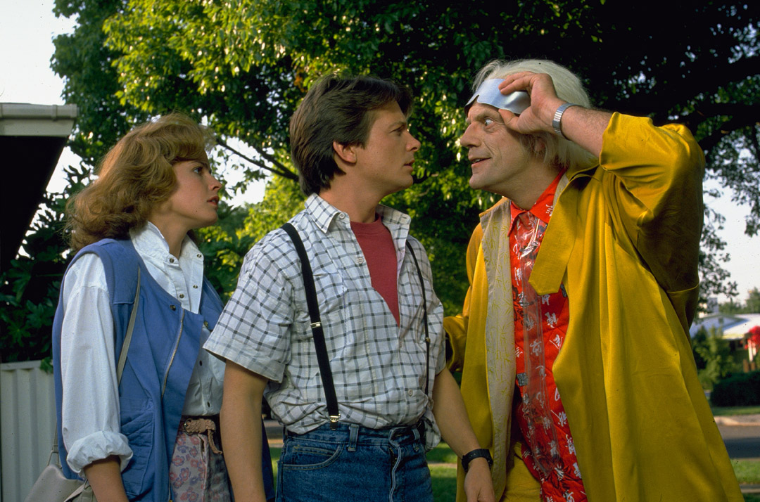 Jennifer Parker (ELISABETH SHUE) and Marty McFly (MICHAEL J. FOX) listen to Doc Brown (CHRISTOPHER LLOYD) as he insists he must take them to the future.