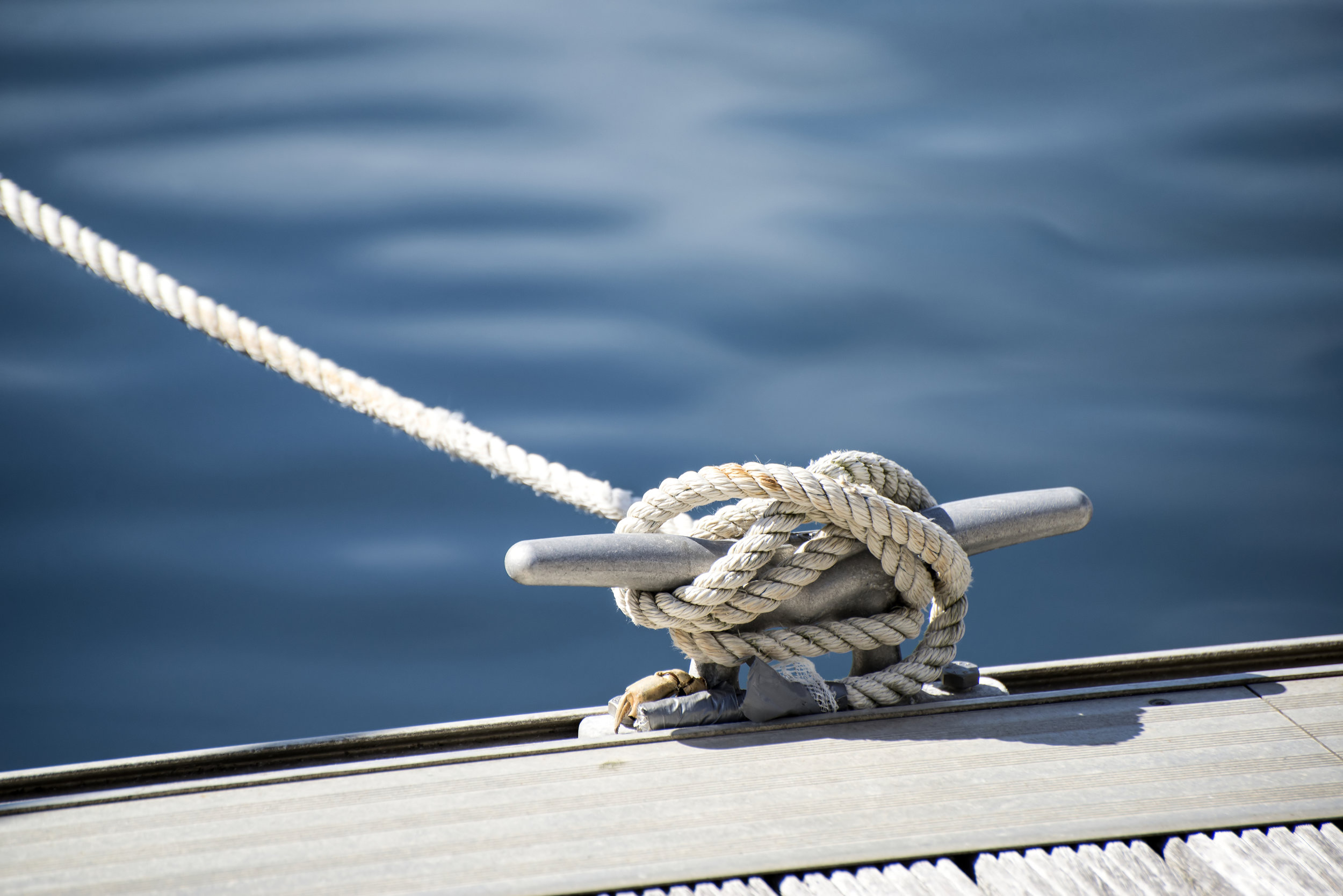 A boat cleat tied with a rope