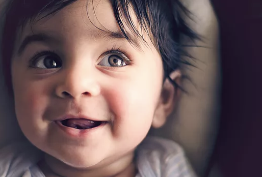 Magic Words Therapy - a smiling baby boy.png