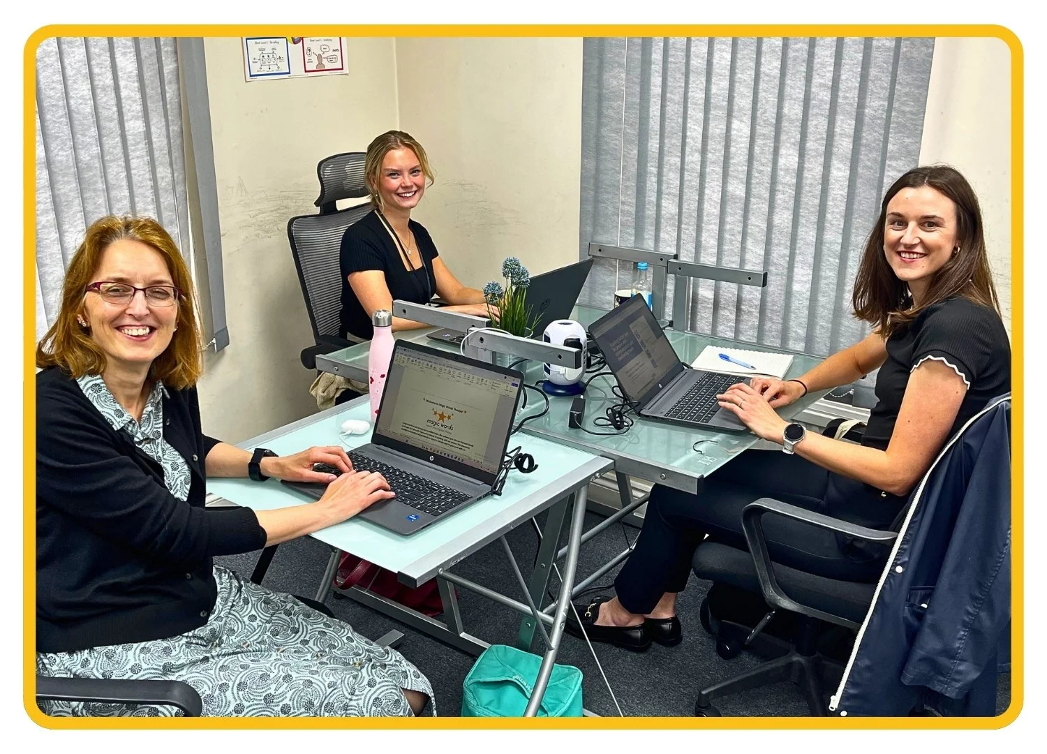 Team of three speech and language therapists sitting at a desk in the Newport Pagnell (Milton Keynes) office.