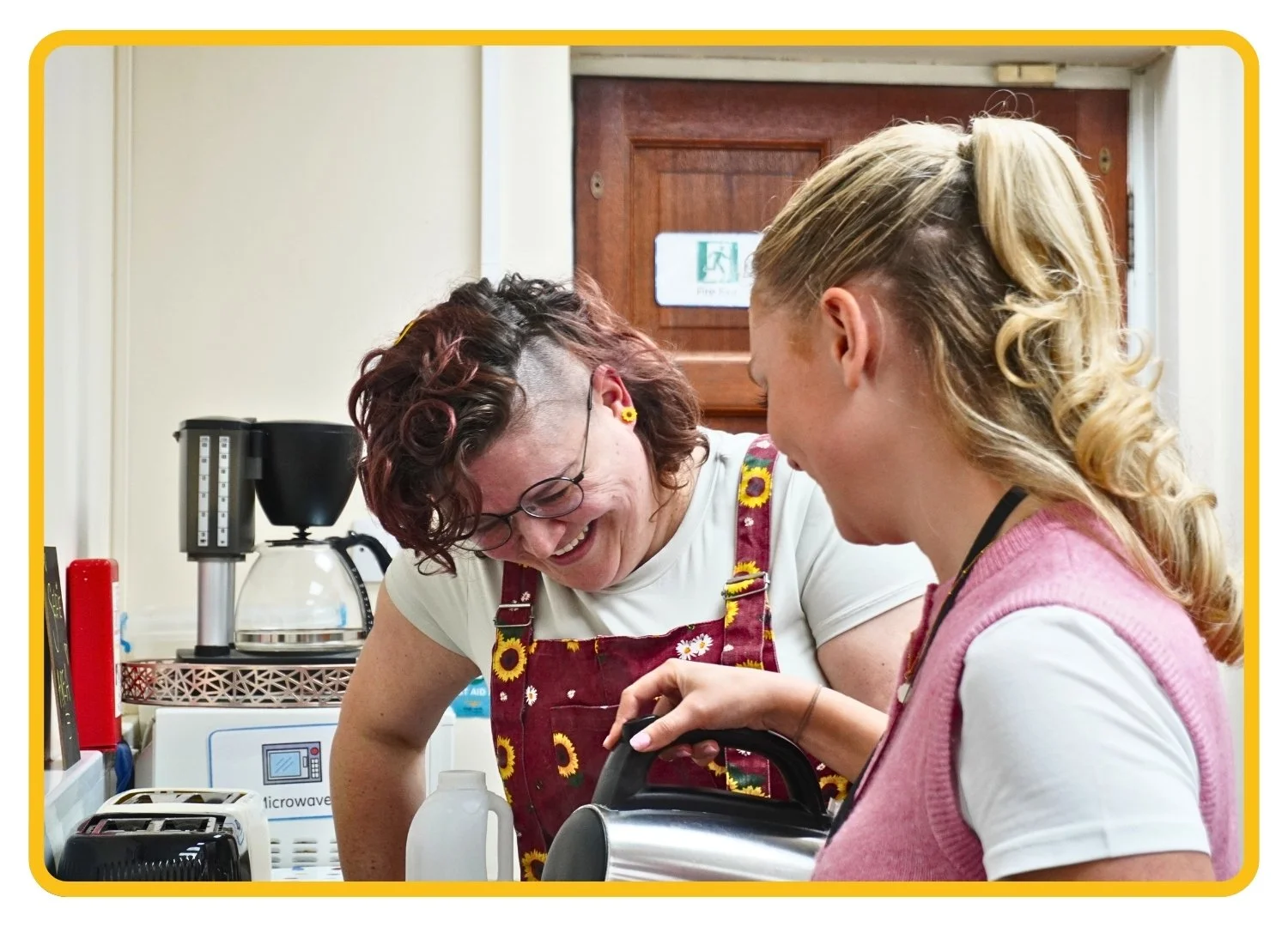Two therapists make a cup of team in the Newport Pagnell clinic kitchen