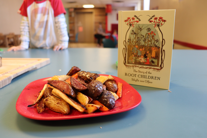 Roasted roots meal in front of "The Story of the Root Children" by Sibylle von Olfers.