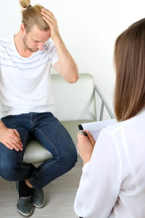 worried man talking to therapist