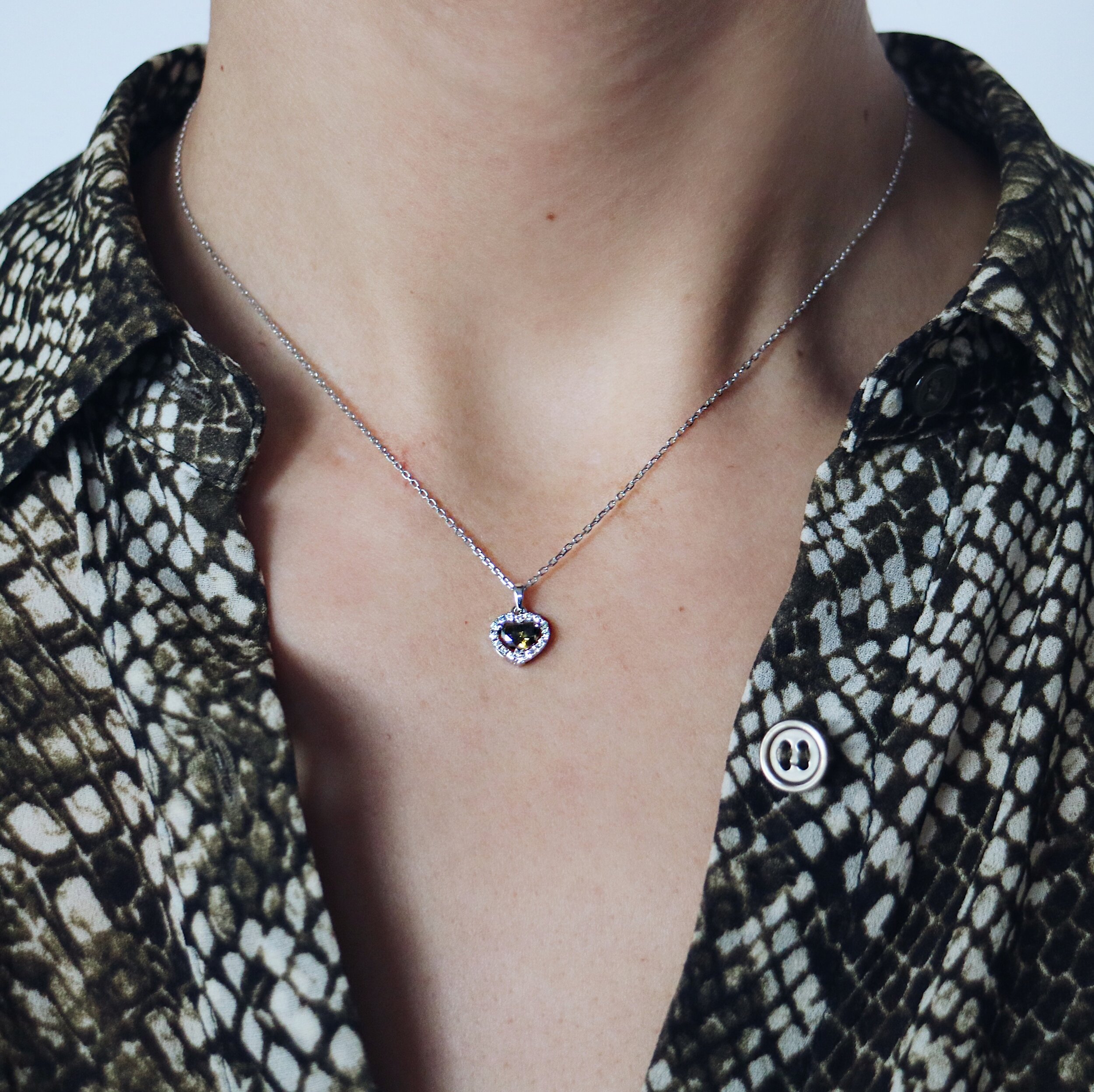Necklace with greenish heart-shaped diamond pendant