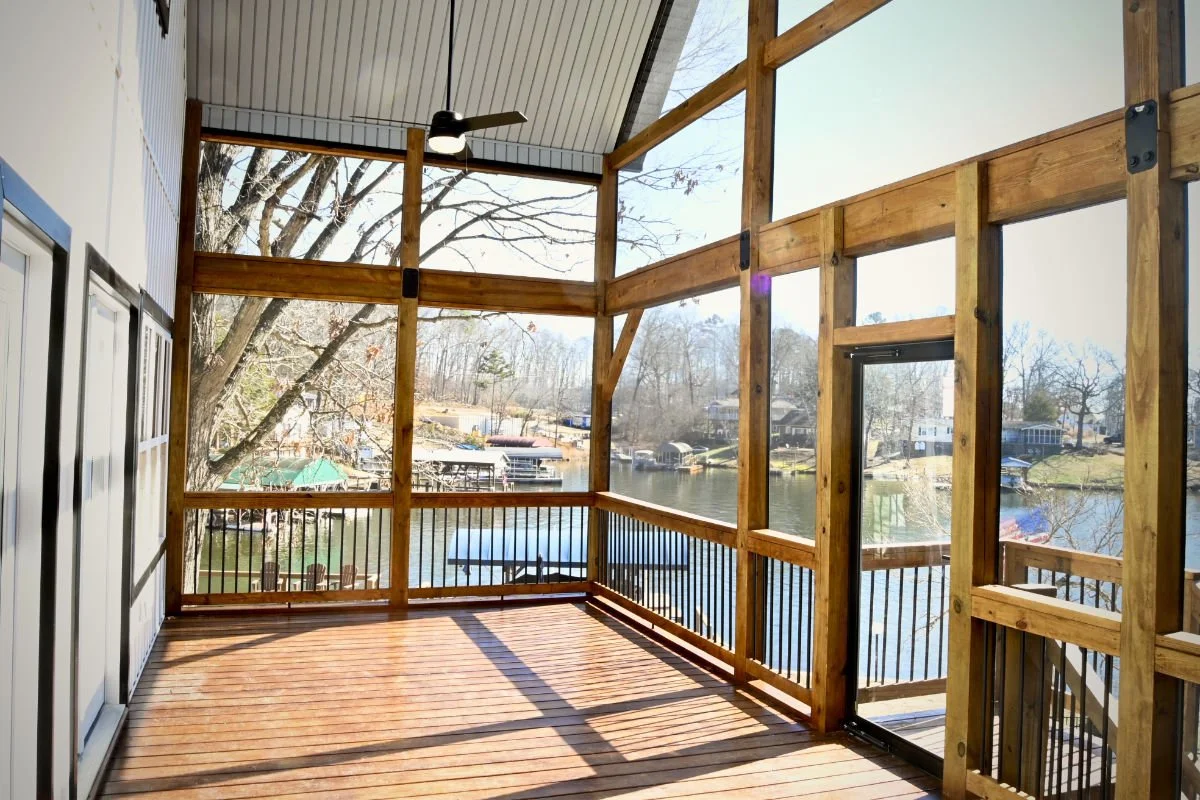 A covered porch overlooking a lake