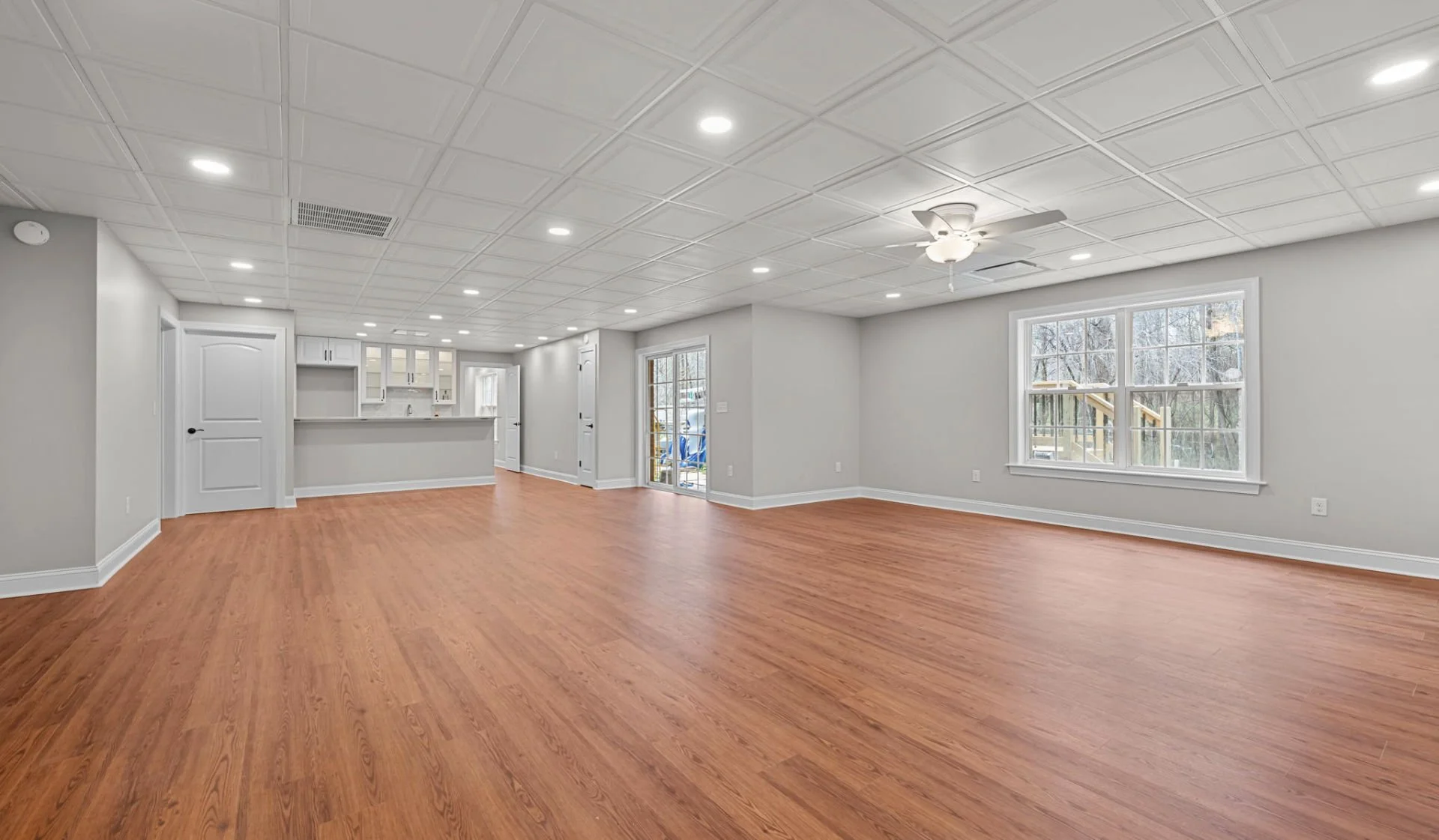 A modern living room and kitchen remodel, with hardwood floors
