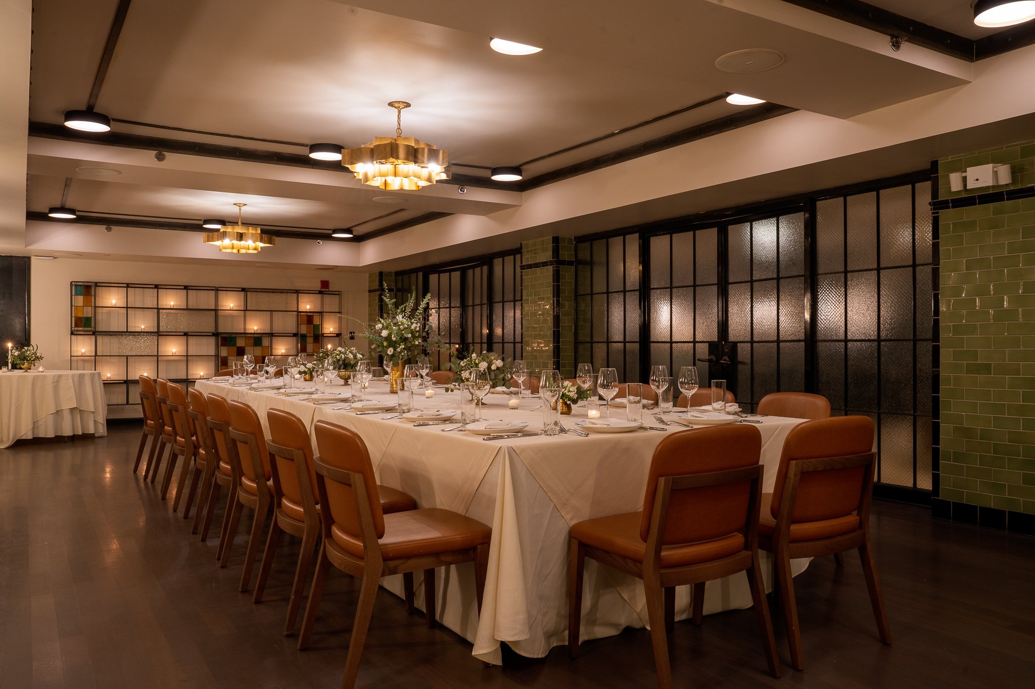 An elegantly set dining table in a room with warm lighting and modern decor