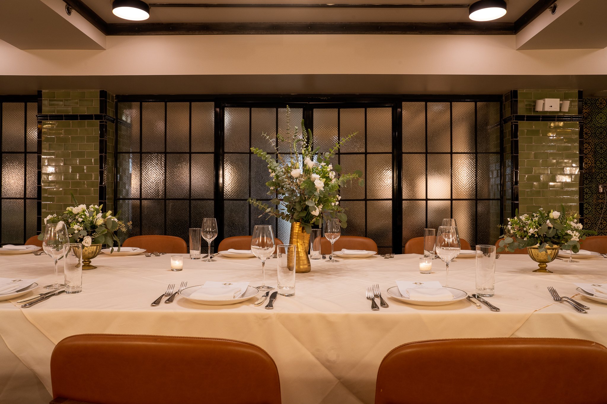 Long table set for intimate private dinner event
