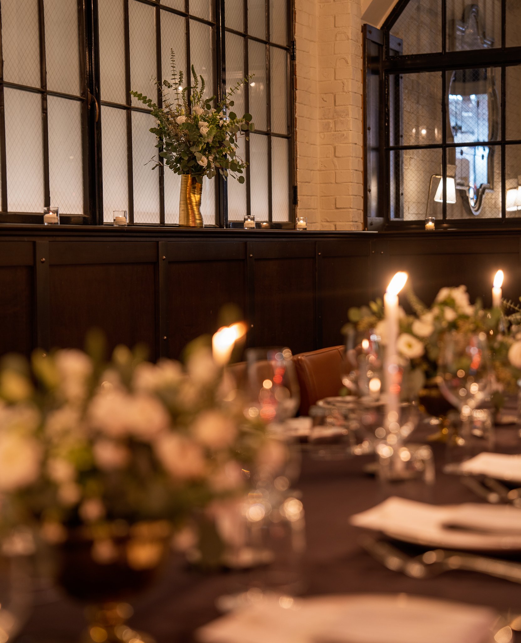 Close-up of table setting with cozy window backdrop.