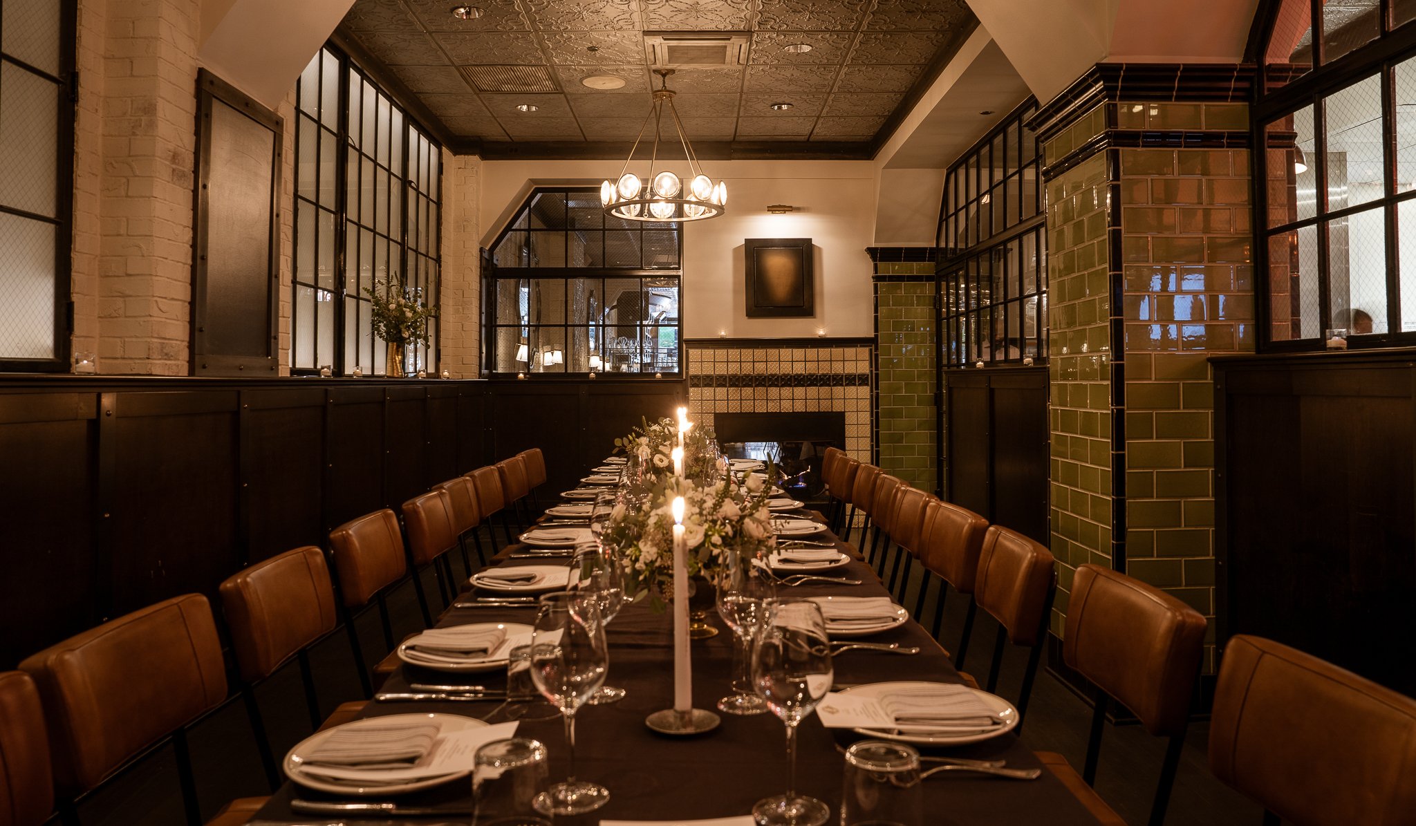 Wide-angle view of warmly lit long table, exuding coziness