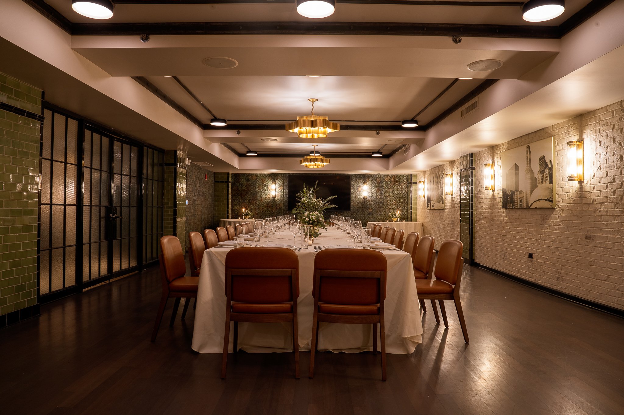Zoomed-out view: spacious private dining room, central table, linens, floral decor.