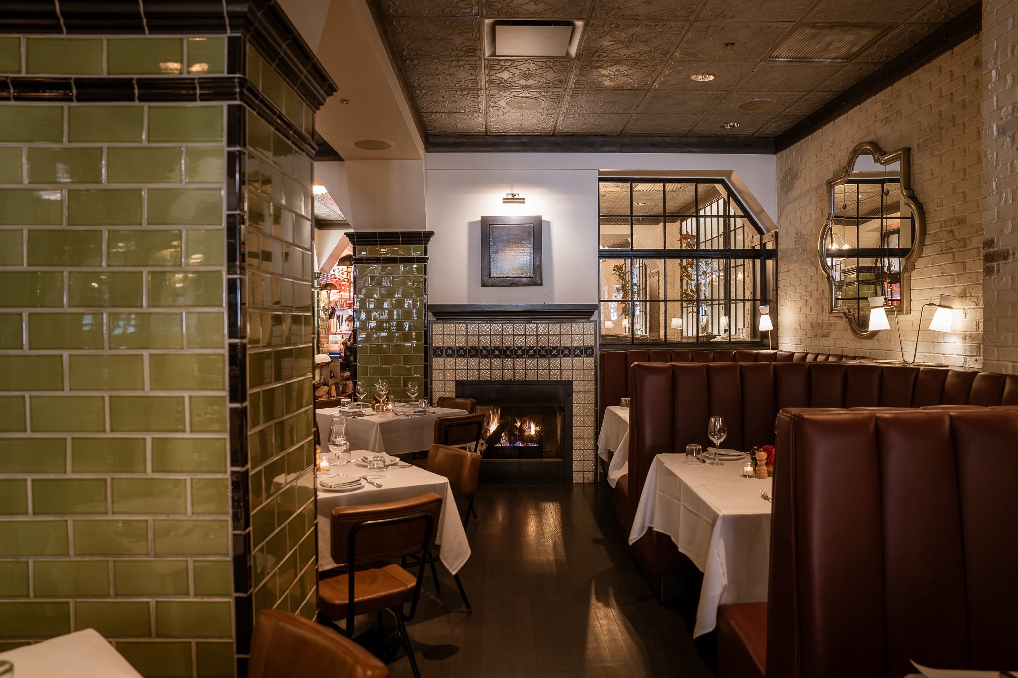 Intimate dining room with cozy circular booths near fireplace, enhancing ambiance.