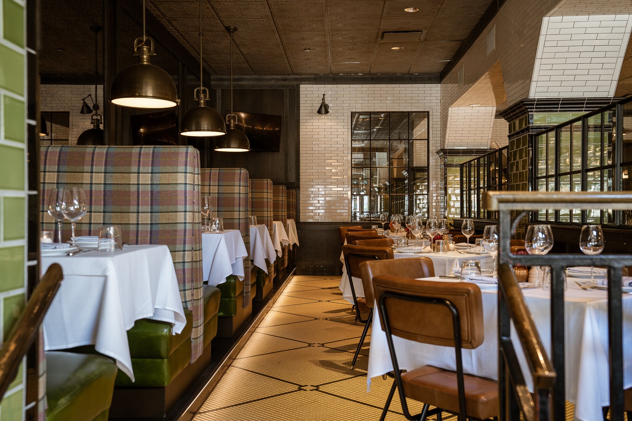 Main dining room booths set up elegantly with white linens.