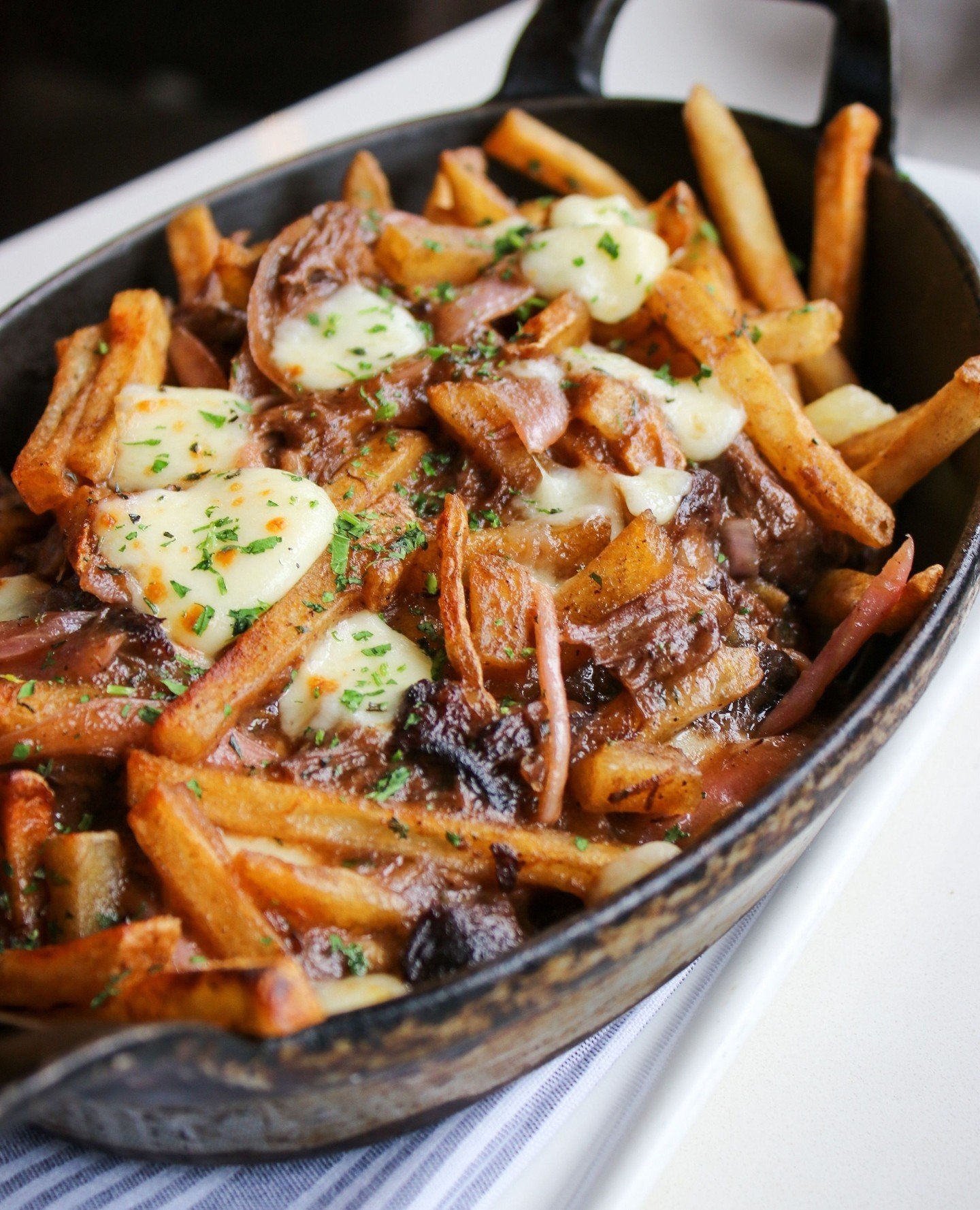 Cheers to National Poutine Day! 🍟🧀⁠
⁠
Whiskey Braised Pork Poutine | fries, wisconsin cheese curds, whiskey braised pork shoulder, pickled red onion, pork gravy