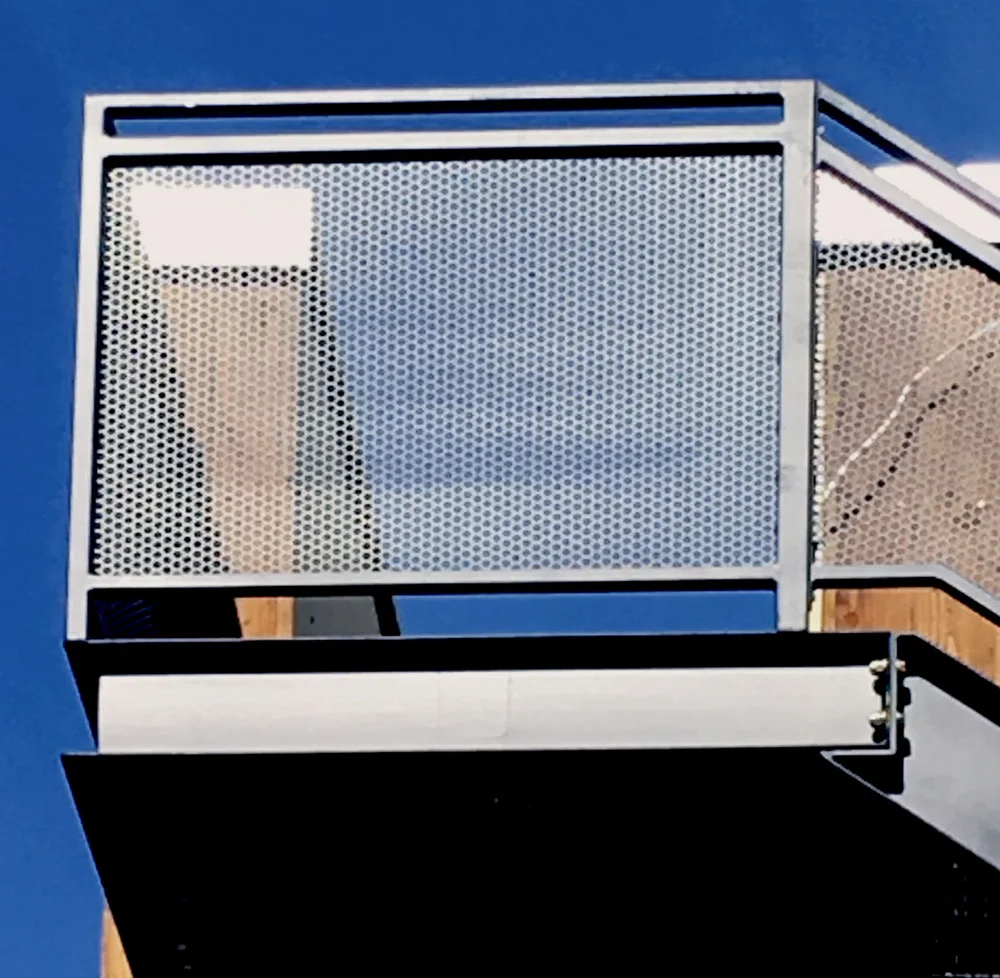 Red iron cantilevered exterior stairway fabricated by New Era Fab