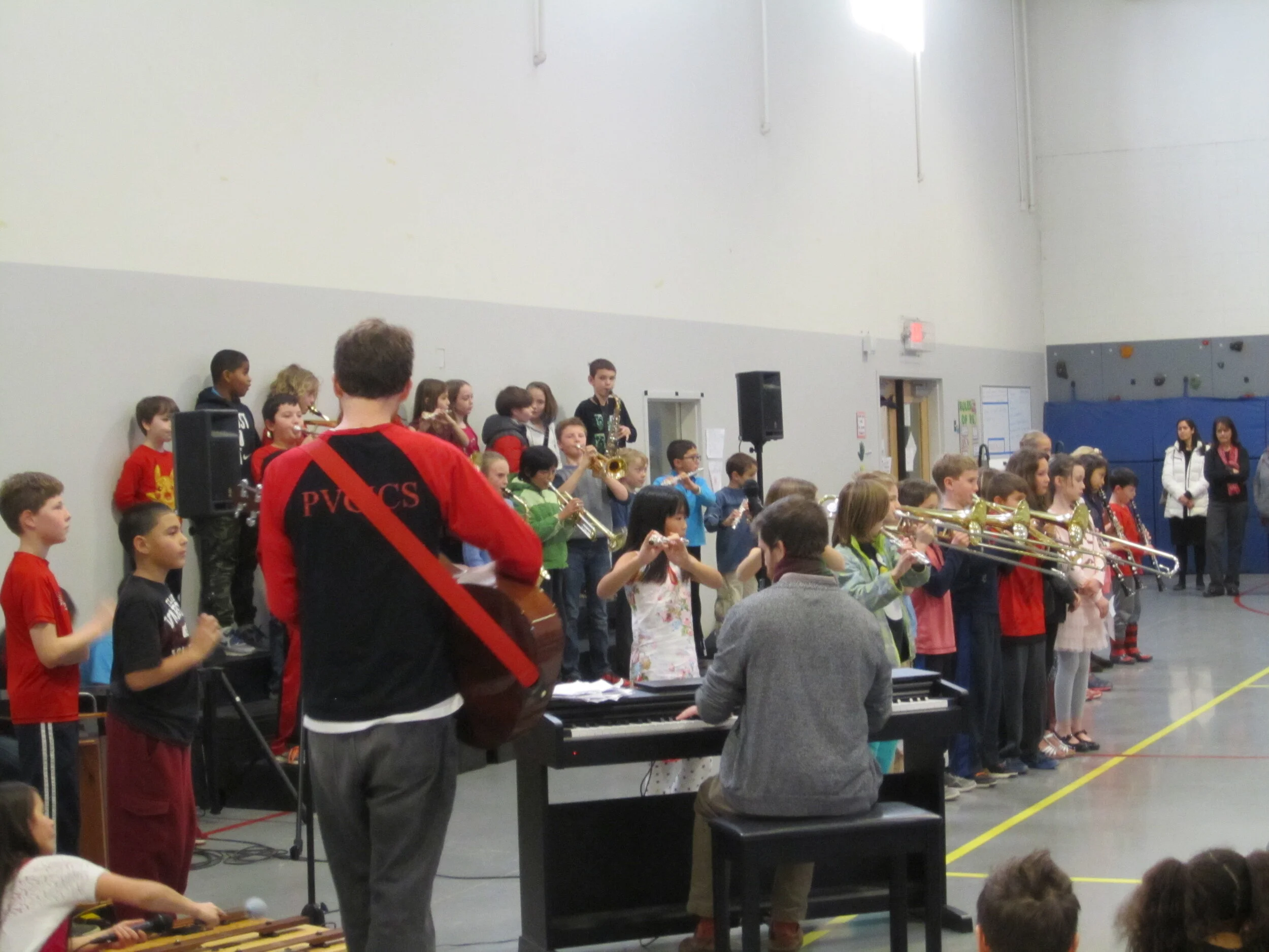 A visiting performer teaching our students about a Chinese musical instrument.