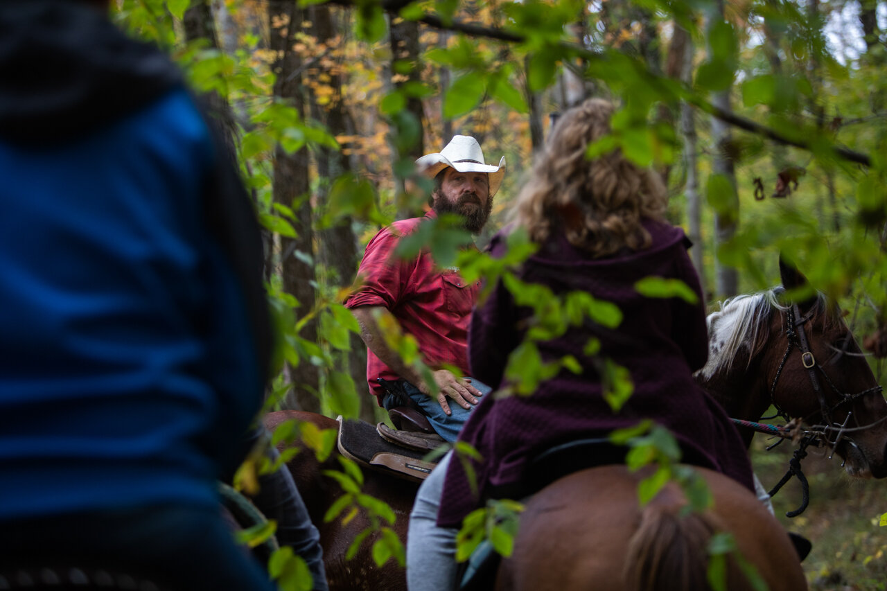  Charlie Musselman watches as Scott Irelan (left) and his daughter Izzy Irelan (right) catch up on their horses during a trail ride around Smoke Rise Ranch on Wednesday, Oct. 22, 2020. Musselman says he enjoys being able to teach others how to ride a