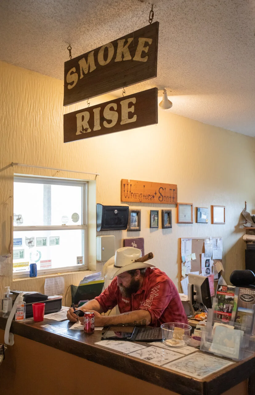  Charlie Musselman sits in the front office and fills out paperwork after finishing a trail ride at Smoke Rise Ranch on Wednesday, Oct. 22, 2020. Musselman studied accounting at Hocking College and then transferred to Ohio University. He says his acc