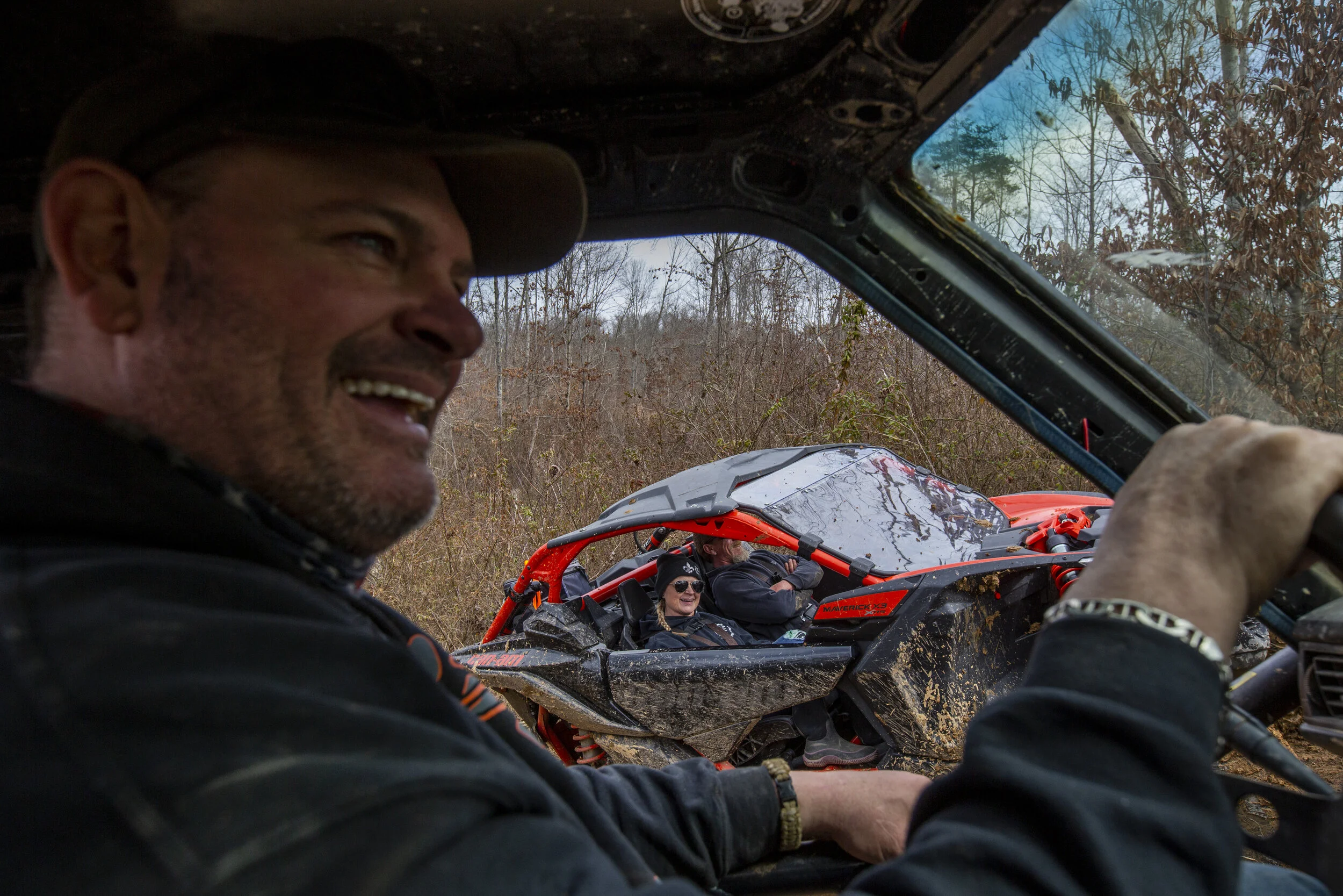  Ryan Peters jokes with his friends as they ride in their off-road vehicles through the trails at an Athens County Crawlers event on Saturday, March 13, 2021. The ACC is an off-road park outside of New Marshfield where Athens County residents and peo